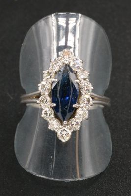 an image of a ring with a blue stone in it
