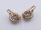 a pair of gold earrings with diamonds on them