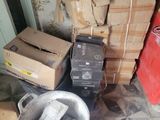 a pile of boxes and a bucket on the floor