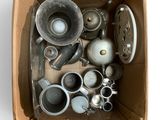 a cardboard box filled with assorted metal items