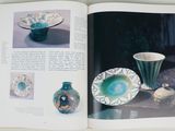 an open book with pictures of vases and bowls on it
