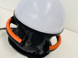 a white and orange light that is on top of a table