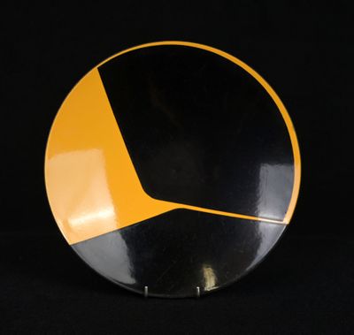 an image of a black and yellow plate on a black background