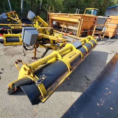 a picture of a yellow machine with a large pipe attached to it ' s back