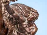 bronze statue of a man and a woman on a horse