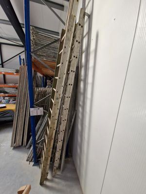 a ladder leaning against a wall in a warehouse
