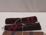 three pieces of cloth are tied together on a white surface