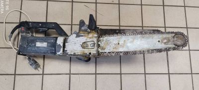 a chainsaw sitting on a tiled floor in a room