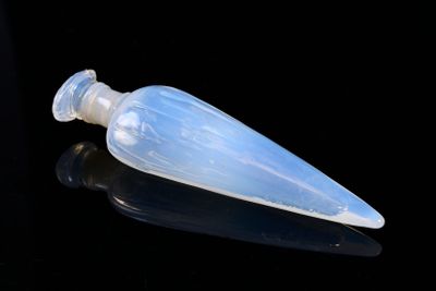 a small plastic bottle with a clear cap on a black surface