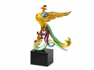 statue of a colorful bird on a black base