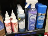 bottles of paint and glue are sitting on a shelf in a store