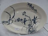 a plate with a bird design on it on a table