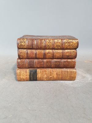 three old books stacked on top of each other on a table