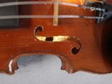 a close up of a violin that is on a table