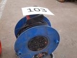 a blue hose sitting on the ground next to a red fire hydrant