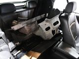 a car that has a cow hider in the back of it