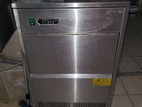 a stainless steel machine that is sitting on a tiled floor