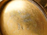 a close up of a gold vase with writing on it