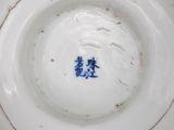 a close up of a plate with a blue and white design