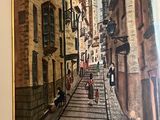 a painting of a street scene with people walking down it
