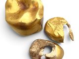 two pieces of gold are sitting next to each other
