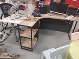 a desk with two computers and a chair in a room