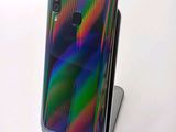a close up of a cell phone on a stand on a table
