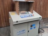 a machine that is sitting in front of a wooden wall