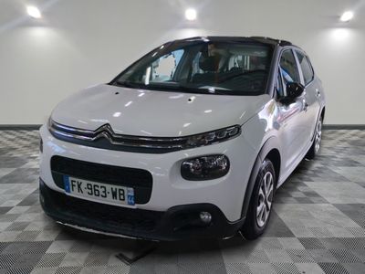 a white car that is parked in a room