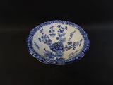 a blue and white bowl sitting on a black table
