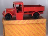 a red toy truck sitting on top of a box