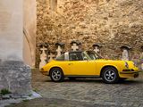 a yellow car that is parked in front of a building