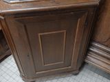 a corner cabinet in the corner of a room