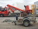a trailer with a crane attached to it in a parking lot