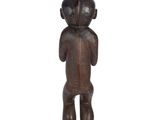 an old wooden statue of a man with a hat on his head