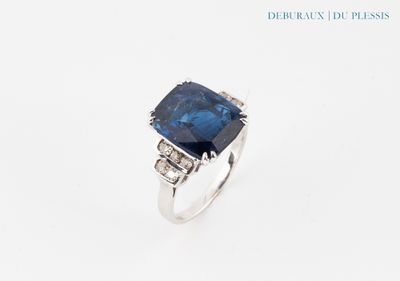 a close up of a ring with a blue stone on it