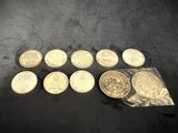 a bunch of coins sitting on top of a table next to a bag