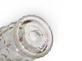 a glass bottle with a label on it on a white surface