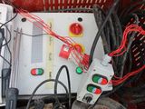 a red basket filled with electrical equipment and a pair of shoes