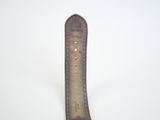 the watch strap is made of brown leather and has a white stitching