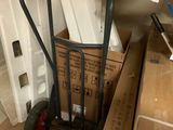 a cart that is sitting on the floor next to a pile of boxes