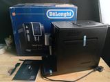 a black computer sitting on a table next to a blue box