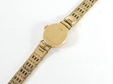 an image of a gold wrist watch with a white background