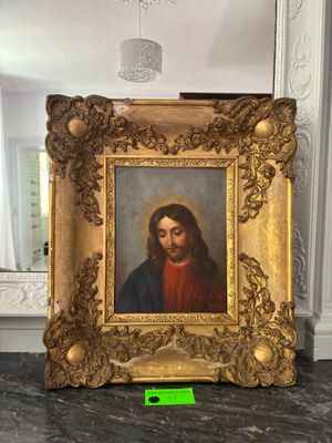 painting of a man with a beard in a gold frame on a marble counter