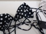 a black and white polka dot bikini set with matching headbands and a drawstring bag