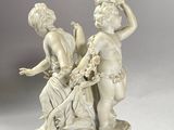 a statue of a boy and a girl on a pedestal