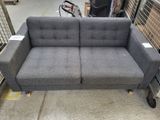 a couch that is sitting on a cart in a warehouse