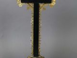 a black cross with a gold cross on top of it
