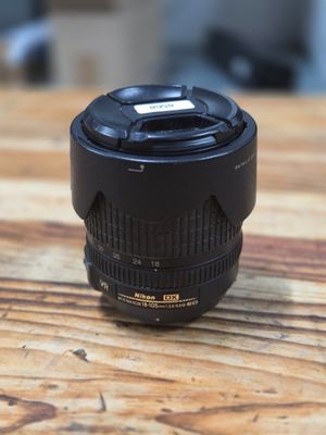 a close up of a camera lens sitting on a wooden table