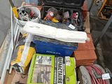 a cart full of tools on the floor in the garage